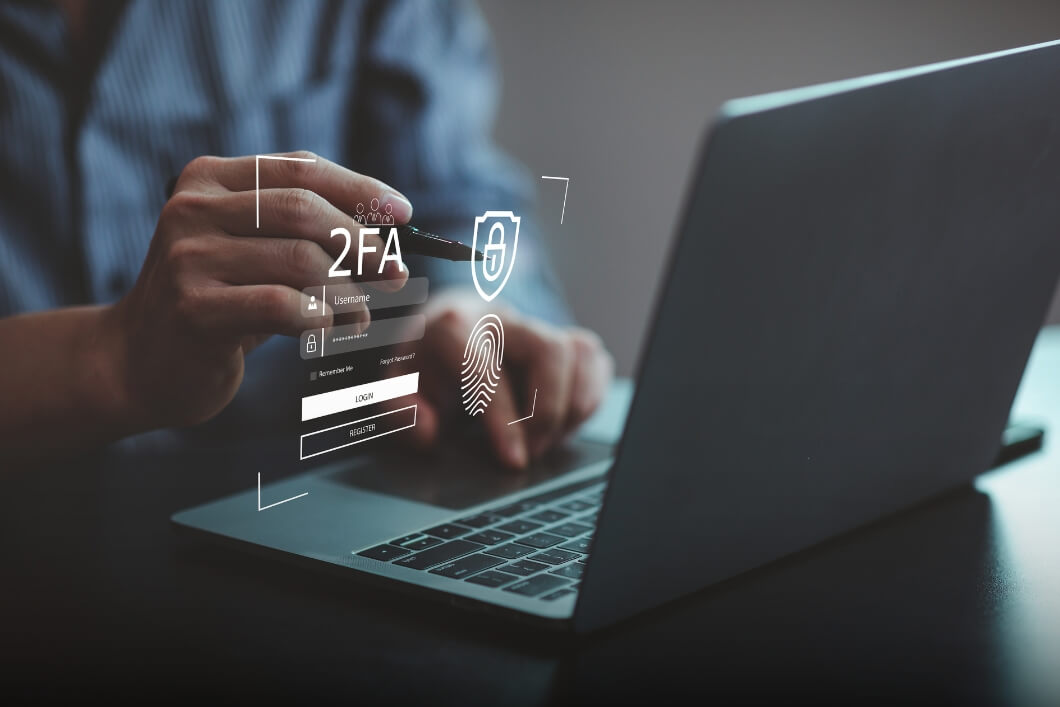 Man at computer doing multi-factor authentication for cybersecurity inspection